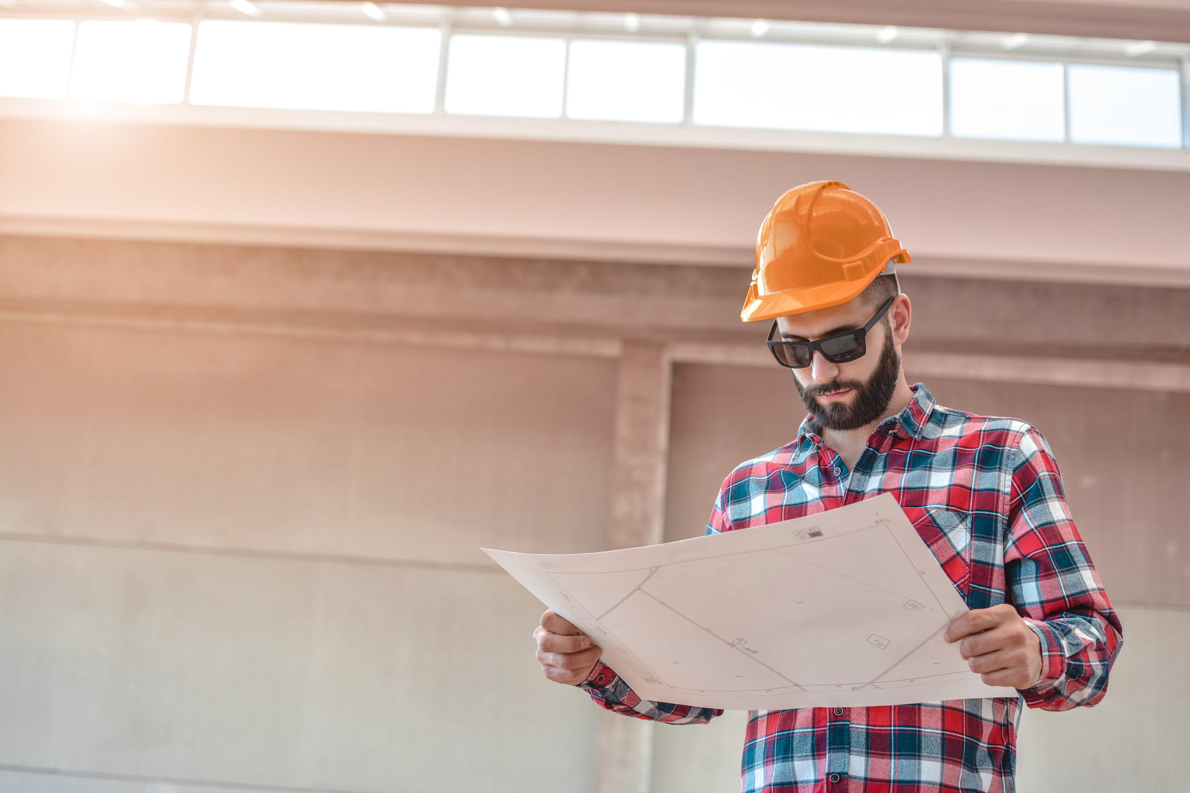 Construction worker reviewing document