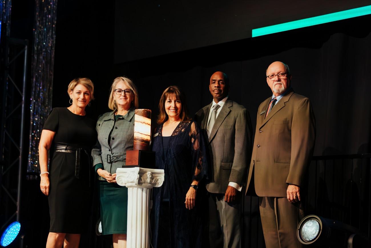 Alba Santiago and Kathy Suttles pictured with Dena Sherrill, VP of Housing, REI Oklahoma; Leon Gray, NeighborWorks America; and Martin VanMeter, Board Member, REI Oklahoma.